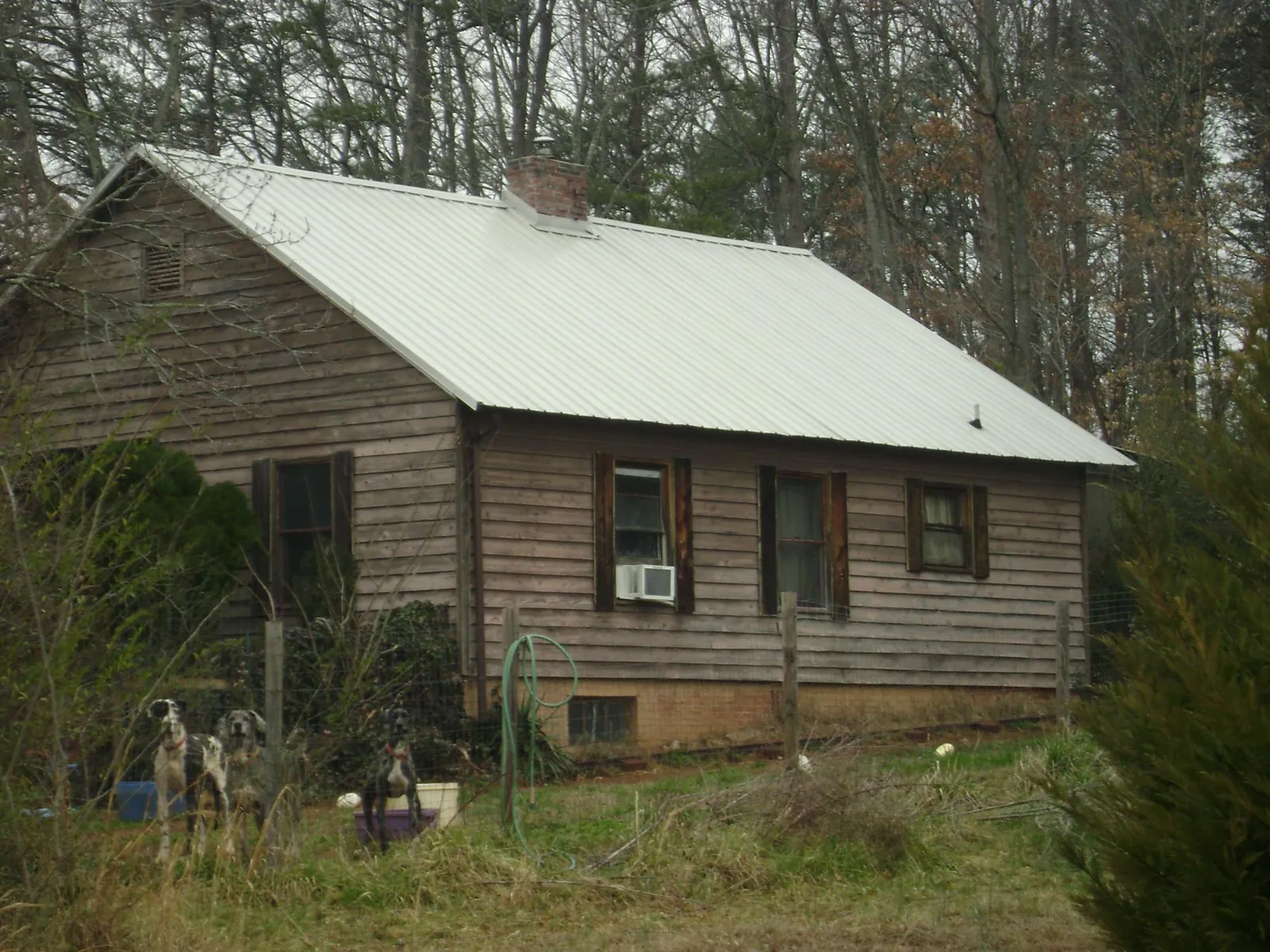White metal roof on an old wood sided farmhouse, from a Metal Roof Installation job in Rosedale